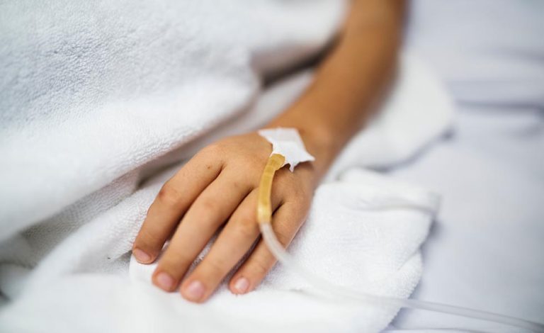 child lays on a gurney with an IV after experiencing child medical malpractice