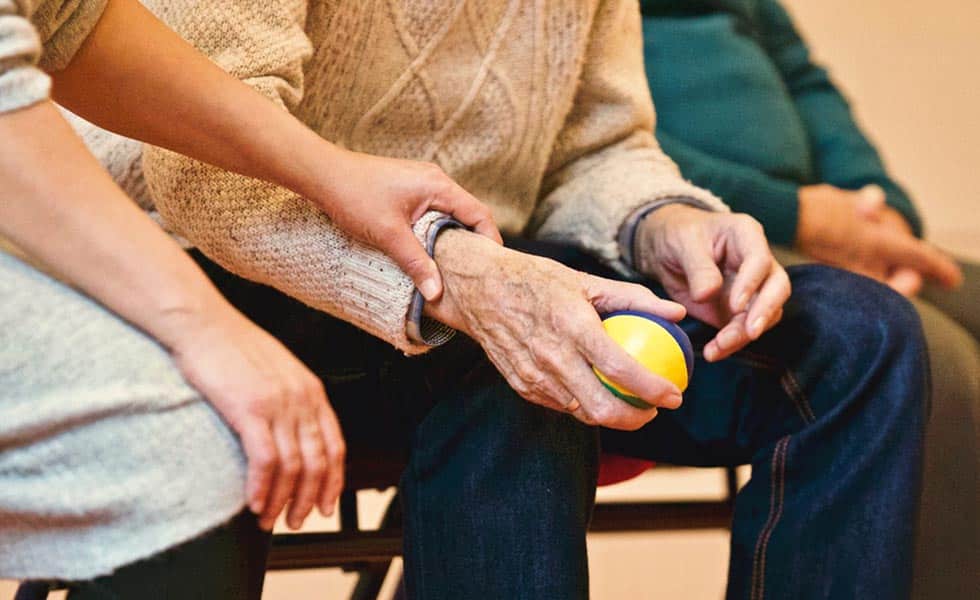 woman comforts man who has experienced nursing home abuse