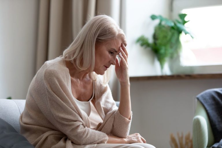 Woman who used roundup sitting with her head in her hands