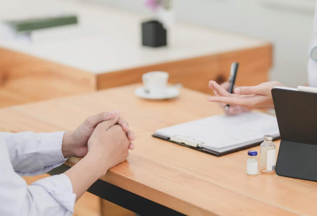 woman discusses loss of wages/ income with her lawyer in an auto accident claim